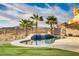Inviting pool area with a waterfall feature, surrounded by lush landscaping and a scenic view at 1223 Casa Palermo Circle Cir, Henderson, NV 89011