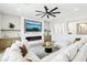 Bright living room with white sectional sofa, fireplace, and modern ceiling fan at 1343 Panini Dr, Henderson, NV 89052