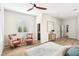 The main bedroom features lots of natural light, modern ceiling fan, and charming pink accent chairs at 1343 Panini Dr, Henderson, NV 89052