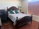Comfortable bedroom showcasing a plush bed, wooden floors, and dark trim at 2180 Polynesia Cir, Henderson, NV 89074