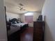 Bedroom features a high ceiling with fan, wood floors, and a large window with a window shade at 2180 Polynesia Cir, Henderson, NV 89074