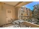 Private balcony with a table and chairs, perfect for outdoor relaxation at 230 E Flamingo Rd # 203, Las Vegas, NV 89169