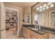 Well-lit bathroom with a vanity, large mirror, and view into the kitchen at 230 E Flamingo Rd # 203, Las Vegas, NV 89169