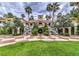 Stately exterior featuring dual staircases, mature landscaping, and a grand entrance at 230 E Flamingo Rd # 203, Las Vegas, NV 89169