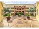 Warm-toned courtyard with center water feature and lush planters surrounded by the building at 230 E Flamingo Rd # 203, Las Vegas, NV 89169