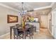 Dining area with elegant lighting fixture adjacent to the kitchen and living room area at 230 E Flamingo Rd # 203, Las Vegas, NV 89169