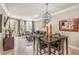 Dining room with modern chandelier, open to the living room, and access to the balcony at 230 E Flamingo Rd # 203, Las Vegas, NV 89169