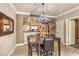 Dining room with modern chandelier adjacent to an open kitchen and hallway doors at 230 E Flamingo Rd # 203, Las Vegas, NV 89169