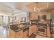 Updated kitchen with stainless steel appliances, granite countertops, and a view into the living area at 230 E Flamingo Rd # 203, Las Vegas, NV 89169