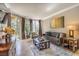 Comfortable living room with a neutral color palette, balcony access, and modern furnishings at 230 E Flamingo Rd # 203, Las Vegas, NV 89169