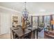 Dining room with chandelier, open to the living room, and balcony access at 230 E Flamingo Rd # 203, Las Vegas, NV 89169