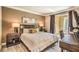 Comfortable bedroom with a large bed, bedside tables, and access to a private balcony at 230 E Flamingo Rd # 203, Las Vegas, NV 89169