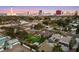 Expansive view of a Las Vegas neighborhood with a blue pool and the city skyline in the background at 2400 Llewellyn Dr, Las Vegas, NV 89102
