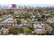 Homes nestled among mature trees in a residential area, with the Las Vegas skyline visible in the background at 2400 Llewellyn Dr, Las Vegas, NV 89102