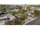 Home with a lush front yard and mature trees in a residential area with city views in the background at 2400 Llewellyn Dr, Las Vegas, NV 89102
