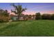 A large backyard with green grass and mature landscaping at 2400 Llewellyn Dr, Las Vegas, NV 89102