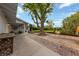 Large backyard with mature trees, brick patio, fountain, and lush landscaping and trees at 2400 Llewellyn Dr, Las Vegas, NV 89102
