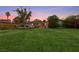 The home's large backyard features lush green grass and mature trees at 2400 Llewellyn Dr, Las Vegas, NV 89102