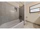 Bathroom features tub/shower, tile floors, marble panel and modern fixtures and natural light at 2400 Llewellyn Dr, Las Vegas, NV 89102