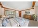 Staged bedroom features large mirrored closet, decorative wood trim, and modern bed and furniture at 2400 Llewellyn Dr, Las Vegas, NV 89102