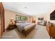 Cozy bedroom with natural light, wood furnishings and comfortable decor and neutral walls at 2400 Llewellyn Dr, Las Vegas, NV 89102