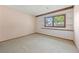 Empty room with wall to wall carpet and classic leaded windows at 2400 Llewellyn Dr, Las Vegas, NV 89102