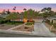 Aerial view of a home featuring a long driveway, a two-car garage, and mature landscaping at 2400 Llewellyn Dr, Las Vegas, NV 89102