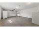 Spacious, all-white garage with roll-up door, washer/dryer hookups, and ample room for multiple vehicles at 2400 Llewellyn Dr, Las Vegas, NV 89102