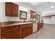 Bright kitchen area with wood cabinets, white appliances, and a sink with large view window at 2400 Llewellyn Dr, Las Vegas, NV 89102