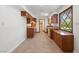 Traditional-style kitchen with tile flooring, wooden cabinets, and lots of natural light from large window at 2400 Llewellyn Dr, Las Vegas, NV 89102