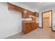 This kitchen has wooden cabinets, tile flooring, and modern appliances at 2400 Llewellyn Dr, Las Vegas, NV 89102
