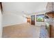 Living room featuring a brick fireplace, tile flooring and a view into the kitchen area at 2400 Llewellyn Dr, Las Vegas, NV 89102