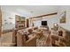 Virtually staged living room with a brick fireplace, a beamed ceiling and comfortable seating at 2400 Llewellyn Dr, Las Vegas, NV 89102