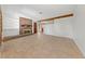 Bright living room with a brick fireplace, beam and tile floors offering a cozy atmosphere at 2400 Llewellyn Dr, Las Vegas, NV 89102