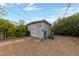 Small wooden shed provides extra storage space, surrounded by foliage and a gravel area at 2400 Llewellyn Dr, Las Vegas, NV 89102