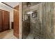 Contemporary tiled shower stall with frameless glass door and brushed nickel fixtures at 2400 Llewellyn Dr, Las Vegas, NV 89102