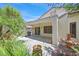 Back patio with lush landscaping and mature palm trees, complete with a built-in BBQ area at 2839 Goldcreek St, Henderson, NV 89052