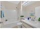 Bright bathroom featuring a shower-tub combo, framed mirror, and a white single sink vanity at 2839 Goldcreek St, Henderson, NV 89052