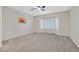 Spacious bedroom with neutral carpet, a ceiling fan, and a large window with white shutters at 2839 Goldcreek St, Henderson, NV 89052