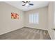 Cozy bedroom with neutral carpet, a ceiling fan, and a window with white shutters at 2839 Goldcreek St, Henderson, NV 89052