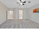 Large bedroom features neutral carpet, a ceiling fan, and ensuite bathroom access at 2839 Goldcreek St, Henderson, NV 89052