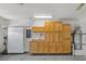 Organized garage featuring ample cabinet space, work bench, and epoxy flooring at 2839 Goldcreek St, Henderson, NV 89052