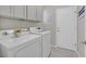 Clean laundry area with washer, dryer, and cabinets for ample storage at 2839 Goldcreek St, Henderson, NV 89052