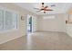Bright living room featuring tile floors, a ceiling fan, and plantation shutters at 2839 Goldcreek St, Henderson, NV 89052