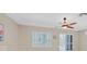 Bright bedroom featuring a ceiling fan, plantation shutters, and access to the backyard at 2839 Goldcreek St, Henderson, NV 89052