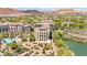 Breathtaking aerial view of a complex near a lake, pool, and lush landscaping at 29 Montelago Blvd # 131, Henderson, NV 89011
