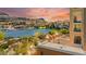 Balcony view overlooking the lake, showcasing waterfront homes and picturesque mountain views at sunset at 29 Montelago Blvd # 131, Henderson, NV 89011