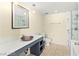 Bright bathroom boasts a modern vanity with decorative bowl sink and tiled walk-in shower at 29 Montelago Blvd # 131, Henderson, NV 89011