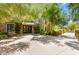 Exterior shot of a building entrance with lush landscaping and inviting benches, creating a welcoming ambiance at 29 Montelago Blvd # 131, Henderson, NV 89011