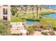 Picturesque view of a lush golf course alongside a tranquil lake, enhanced by swaying palm trees at 29 Montelago Blvd # 131, Henderson, NV 89011
